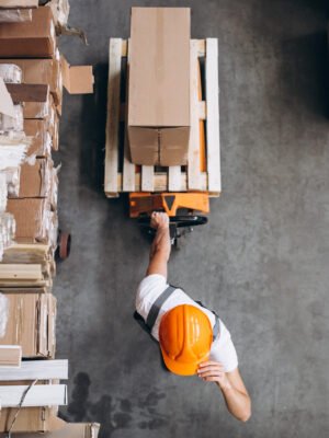 Young man working at a warehouse with boxes